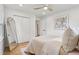 Bright bedroom featuring hardwood floors, closet doors, a full length mirror, and a ceiling fan at 1869 Hebron Hills Dr, Tucker, GA 30084