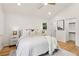 Bright bedroom featuring hardwood floors, neutral walls, a ceiling fan, and access to a walk-in closet at 1869 Hebron Hills Dr, Tucker, GA 30084