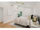 Bedroom with hardwood floors, neutral walls, ceiling fan, and a decorative house plant at 1869 Hebron Hills Dr, Tucker, GA 30084