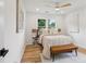 Cozy bedroom featuring hardwood floors, neutral walls, a ceiling fan, and a leather bench at 1869 Hebron Hills Dr, Tucker, GA 30084
