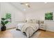 Bedroom with hardwood floors, large windows, neutral walls, ceiling fan, and a decorative house plant at 1869 Hebron Hills Dr, Tucker, GA 30084