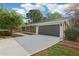 Home exterior showing an expansive driveway and a spacious two car garage at 1869 Hebron Hills Dr, Tucker, GA 30084
