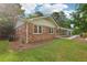Brick house with a well-manicured lawn, and trees surrounding the property at 1869 Hebron Hills Dr, Tucker, GA 30084