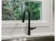 Close-up of kitchen faucet with a view of the outdoors through a bright window at 1869 Hebron Hills Dr, Tucker, GA 30084