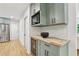 Extended kitchen area with a wine cooler, built-in microwave, and butcher block countertop at 1869 Hebron Hills Dr, Tucker, GA 30084