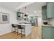 Stylish kitchen with a breakfast bar, sage cabinets, and modern pendant lighting at 1869 Hebron Hills Dr, Tucker, GA 30084