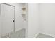 Laundry room with geometric-patterned floors, modern shelving, and ample space at 1869 Hebron Hills Dr, Tucker, GA 30084