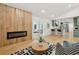 Bright living room with a modern fireplace, hardwood floors, and a kitchen with green cabinets at 1869 Hebron Hills Dr, Tucker, GA 30084