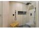 Luxurious tiled shower with a bench, rainfall showerhead, and modern fixtures at 1869 Hebron Hills Dr, Tucker, GA 30084