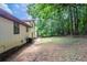A view of the backyard and the exterior of the home, showing the potential for outdoor entertainment at 2247 Cherokee Valley Dr, Lithonia, GA 30058
