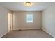 Neutral bedroom with a window and neutral walls and carpeting at 2247 Cherokee Valley Dr, Lithonia, GA 30058