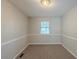 Neutral bedroom with a window and neutral walls and carpeting at 2247 Cherokee Valley Dr, Lithonia, GA 30058