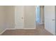 Bedroom featuring neutral carpet and two doors to other rooms at 2247 Cherokee Valley Dr, Lithonia, GA 30058