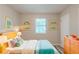 Bright bedroom with colorful decor, comfortable bedding, and ample natural light for a relaxing retreat at 2247 Cherokee Valley Dr, Lithonia, GA 30058