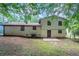 The back of the house has easy access to the spacious backyard through a dark paneled back door and small patio area at 2247 Cherokee Valley Dr, Lithonia, GA 30058