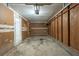 Unfinished garage with shelving and a concrete floor at 2247 Cherokee Valley Dr, Lithonia, GA 30058