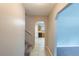 Well-lit hallway with stairs, tile flooring, and views into the kitchen and living areas at 2247 Cherokee Valley Dr, Lithonia, GA 30058