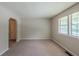 Spacious living room featuring plush carpeting, natural light, and an open layout for comfortable living at 2247 Cherokee Valley Dr, Lithonia, GA 30058