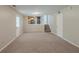 Living room offers kitchen view, neutral walls and carpeting and a stairway at 2247 Cherokee Valley Dr, Lithonia, GA 30058