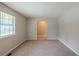 Bright living room with plush carpeting, natural light, and neutral walls creating a comfortable atmosphere at 2247 Cherokee Valley Dr, Lithonia, GA 30058