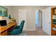 Functional home office featuring a wooden desk, comfortable chair, and built-in shelving for organization at 2247 Cherokee Valley Dr, Lithonia, GA 30058
