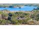 Stunning aerial view of a lakeside home nestled among lush green trees and serene blue waters at 3735 Tamiami Trl, Cumming, GA 30041