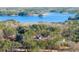 Aerial shot of a home nestled among trees with a lake in the background at 3735 Tamiami Trl, Cumming, GA 30041