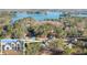 An aerial view of a lakefront community showcasing lush trees, new homes, and lake views at 3735 Tamiami Trl, Cumming, GA 30041