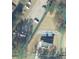 Aerial view of the property with a treed lot located at 3735 Tamiami Trail at 3735 Tamiami Trl, Cumming, GA 30041