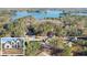 Beautiful lakefront property featuring a modern home surrounded by mature trees, plus a front view insert at 3735 Tamiami Trl, Cumming, GA 30041