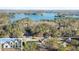 Aerial view of a lakefront property with several homes surrounded by trees and water at 3735 Tamiami Trl, Cumming, GA 30041