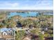 Breathtaking aerial view showcasing the home's proximity to the lake and surrounding forest at 3735 Tamiami Trl, Cumming, GA 30041