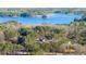Panoramic aerial view of a beautiful home nestled among trees with a serene lake backdrop at 3735 Tamiami Trl, Cumming, GA 30041