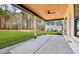 Covered back porch with ceiling fan overlooking a spacious backyard with mature trees at 3735 Tamiami Trl, Cumming, GA 30041