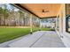 Back porch with a stained wood ceiling, a ceiling fan, and a view of the expansive yard at 3735 Tamiami Trl, Cumming, GA 30041