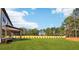 Expansive backyard with lush green lawn and trees surrounding the property at 3735 Tamiami Trl, Cumming, GA 30041