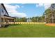 Large backyard with sod and a backdrop of mature trees at 3735 Tamiami Trl, Cumming, GA 30041