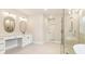 Bright bathroom with double vanity, large mirrors, and glass-enclosed shower at 3735 Tamiami Trl, Cumming, GA 30041