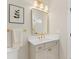 Well-lit bathroom vanity area with a gold-framed mirror, modern sink, and light gray cabinets at 3735 Tamiami Trl, Cumming, GA 30041