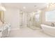 A spacious primary bathroom with double vanity, large glass shower, and luxurious soaking tub at 3735 Tamiami Trl, Cumming, GA 30041