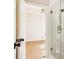 Modern bathroom featuring a glass-enclosed shower with brushed gold hardware and tile surround at 3735 Tamiami Trl, Cumming, GA 30041