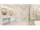 A clean and well-lit primary bathroom featuring a double vanity and glass-enclosed shower at 3735 Tamiami Trl, Cumming, GA 30041