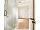 Bright bathroom featuring a walk-in shower, wood floors, and stylish fixtures at 3735 Tamiami Trl, Cumming, GA 30041