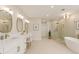 A luxurious primary bath with double vanity, soaking tub, and a separate glass-enclosed shower at 3735 Tamiami Trl, Cumming, GA 30041