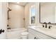 Bathroom featuring modern fixtures, a shower-tub combo, and bright natural lighting at 3735 Tamiami Trl, Cumming, GA 30041