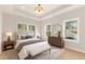 Bright bedroom with large windows, a bench, and a stylish dresser and decor at 3735 Tamiami Trl, Cumming, GA 30041