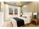 Well-lit bedroom with a large window and neutral tones, creating a peaceful atmosphere at 3735 Tamiami Trl, Cumming, GA 30041