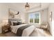 Stylish bedroom with a large window, neutral decor, and a comfortable upholstered bed at 3735 Tamiami Trl, Cumming, GA 30041