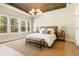 Spacious bedroom with ceiling detail, many windows, and neutral decor at 3735 Tamiami Trl, Cumming, GA 30041