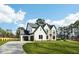 Stunning two-story home featuring a manicured lawn, black trim, and an attached two-car garage at 3735 Tamiami Trl, Cumming, GA 30041